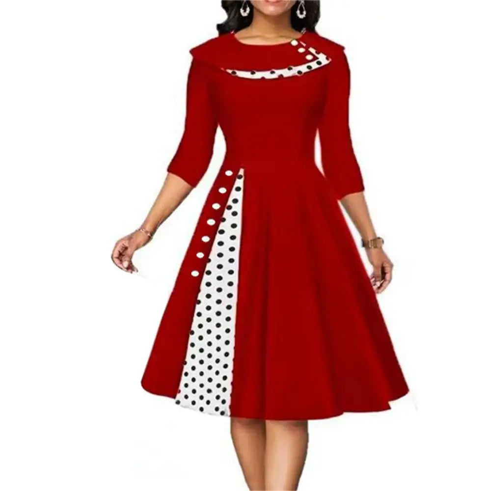 Red vintage women's swing dress with contrasting white polka dot side panel and flared skirt