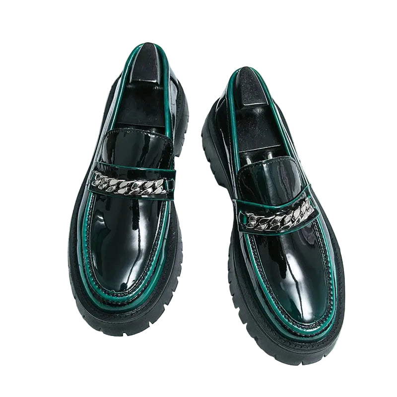 Black and green shoes with chain detail on a grid background