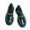 Black and green shoes with chain detail on a grid background