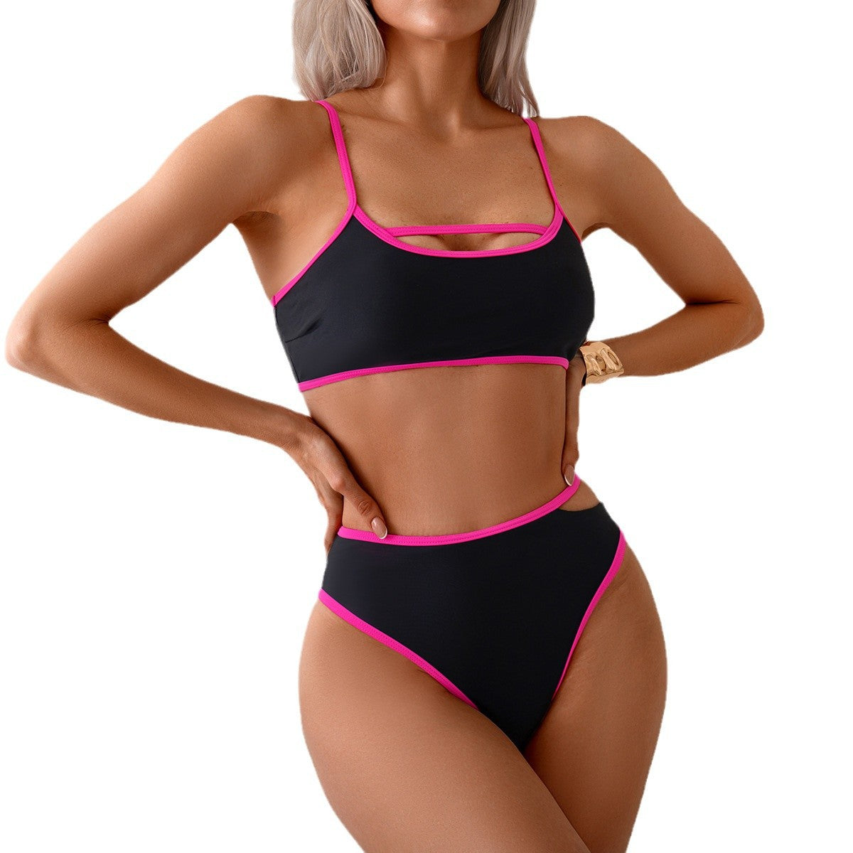 Black bikini with pink accents worn by a model on a white background