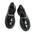 Black glossy loafers with chain detail on a grid background