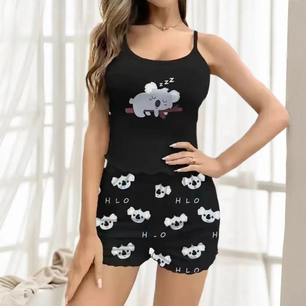 Black pajama set with koala design worn by a model indoors.