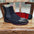 Black suede boot with silver spikes on a wooden chair