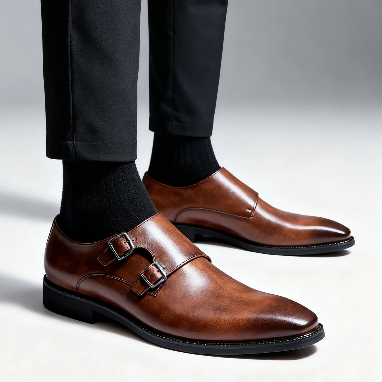 Brown dress shoes with a buckle on a neutral background