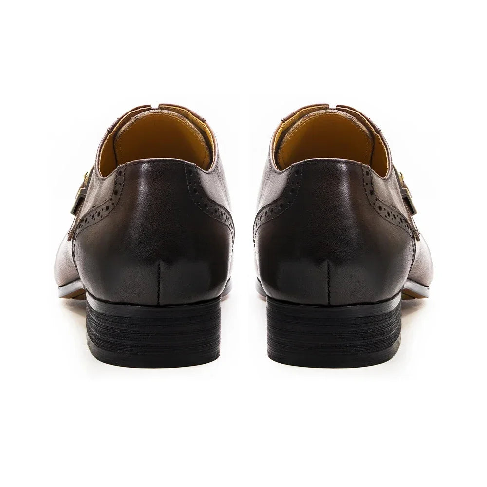 Brown leather shoes with brown soles on a white background