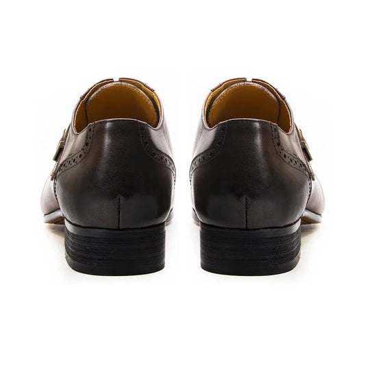 Brown leather shoes with brown soles on a white background