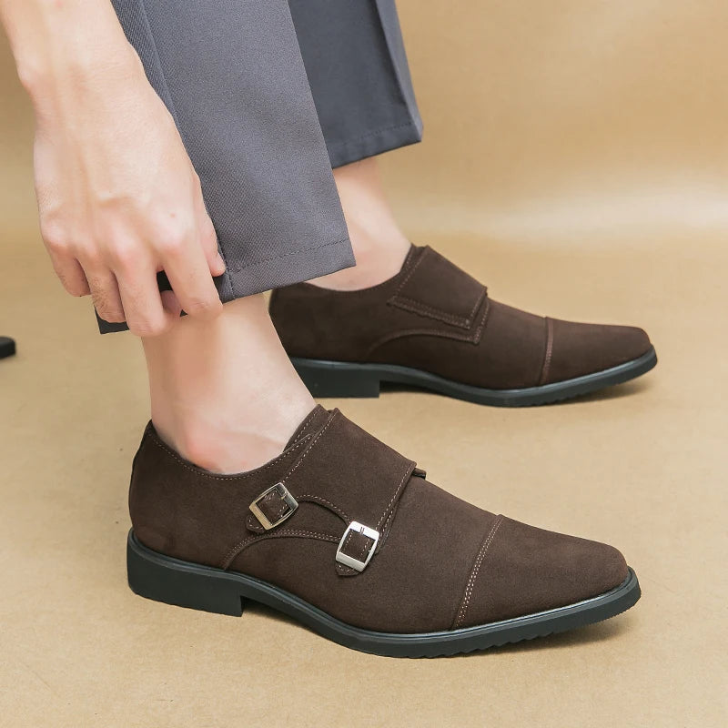 Brown monk strap shoes worn with gray pants on a beige background