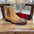 A brown suede Chelsea boot with a studded design on a wooden chair.