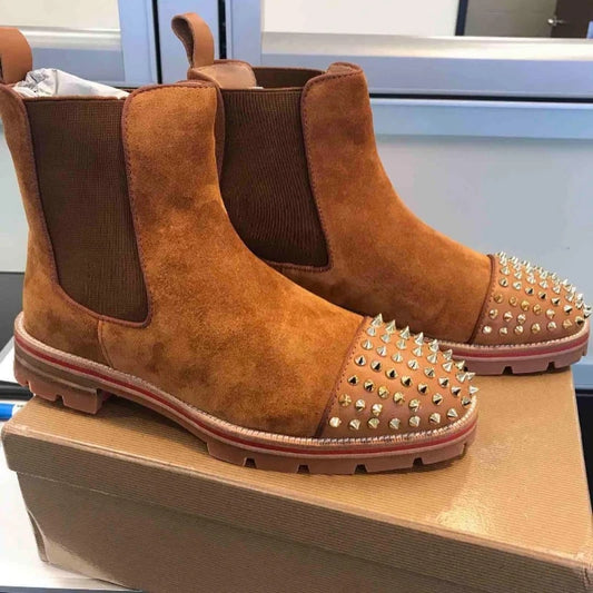 Brown suede boots with studded design in a cardboard box