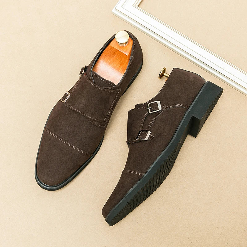 Brown suede shoes with buckles on a beige surface