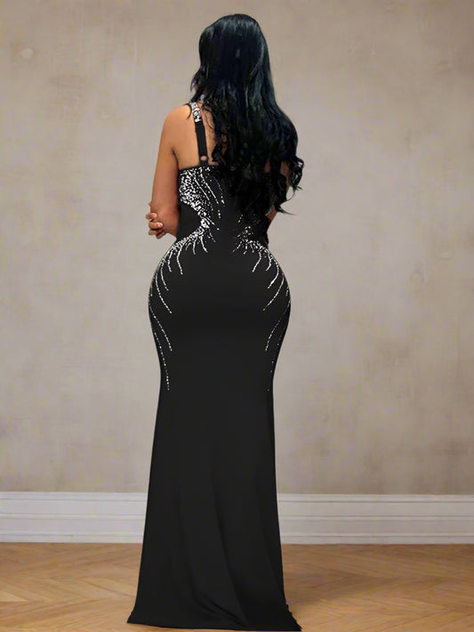 Woman in a black evening gown and a gold birdcage in the background