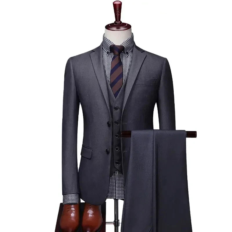 Gray suit with tie and pants on a mannequin against a white background