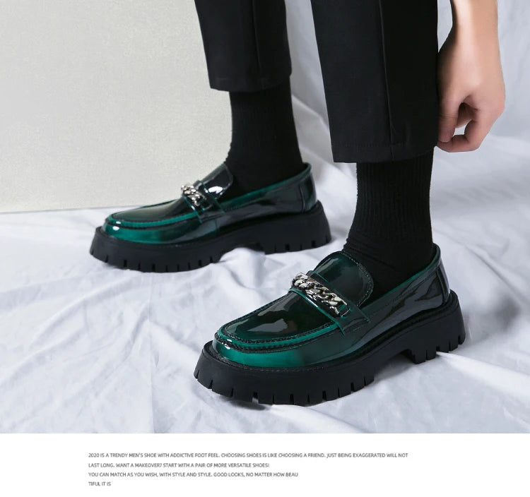 Green and black shoes worn with black pants on a white background
