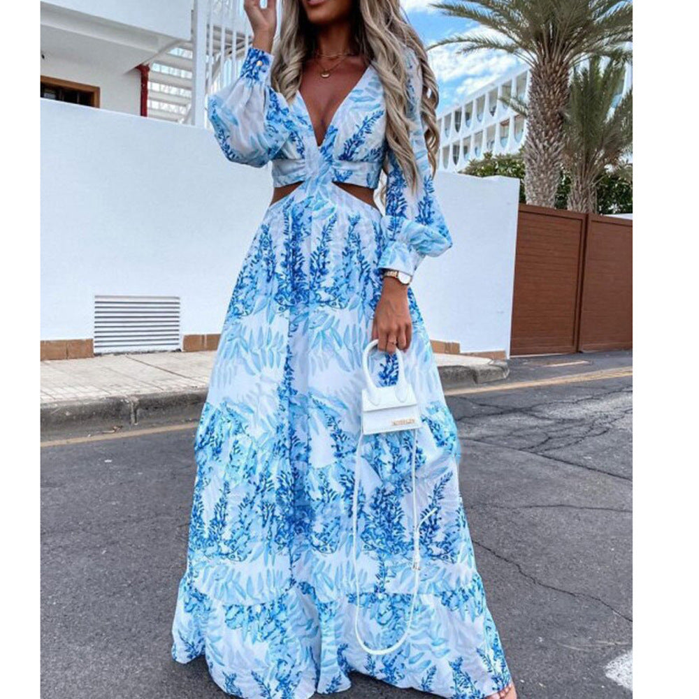 Woman wearing a blue and white patterned dress on a street with palm trees in the background