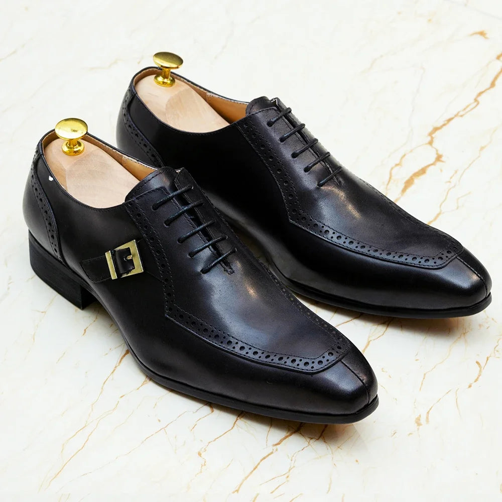 Pair of black dress shoes on a marble surface
