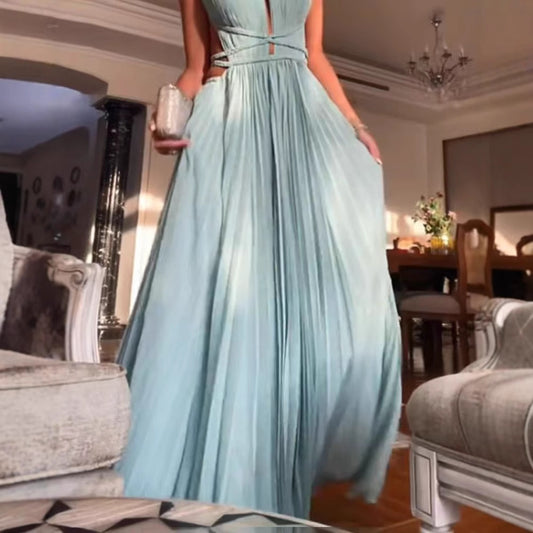 Person wearing a light blue evening gown in an elegant room.