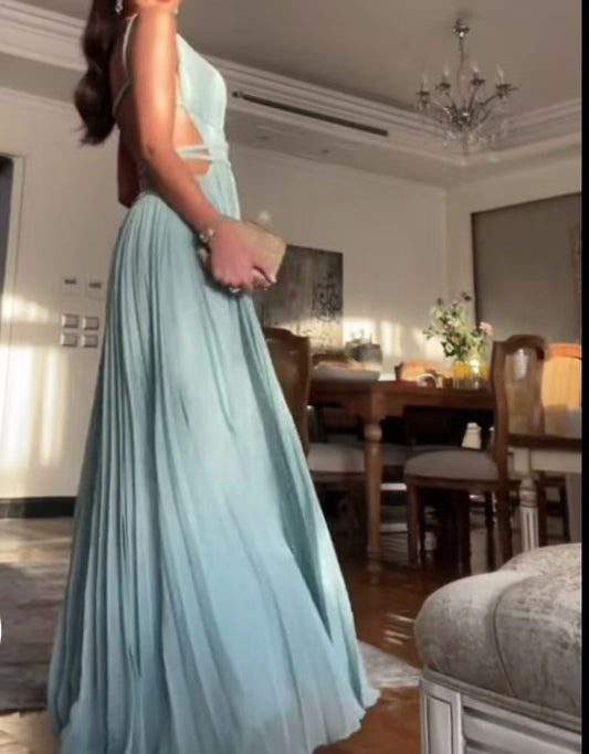 Person wearing a light blue dress in a dining room setting