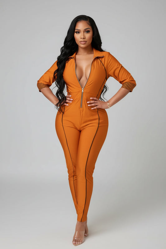 Person wearing an orange jumpsuit standing on a staircase.