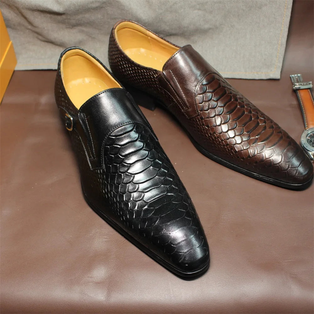 Pair of black and brown textured dress shoes on a brown surface.