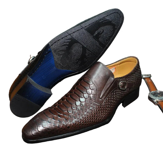 Brown leather shoe with textured sole on a brown surface, with a watch partially visible.
