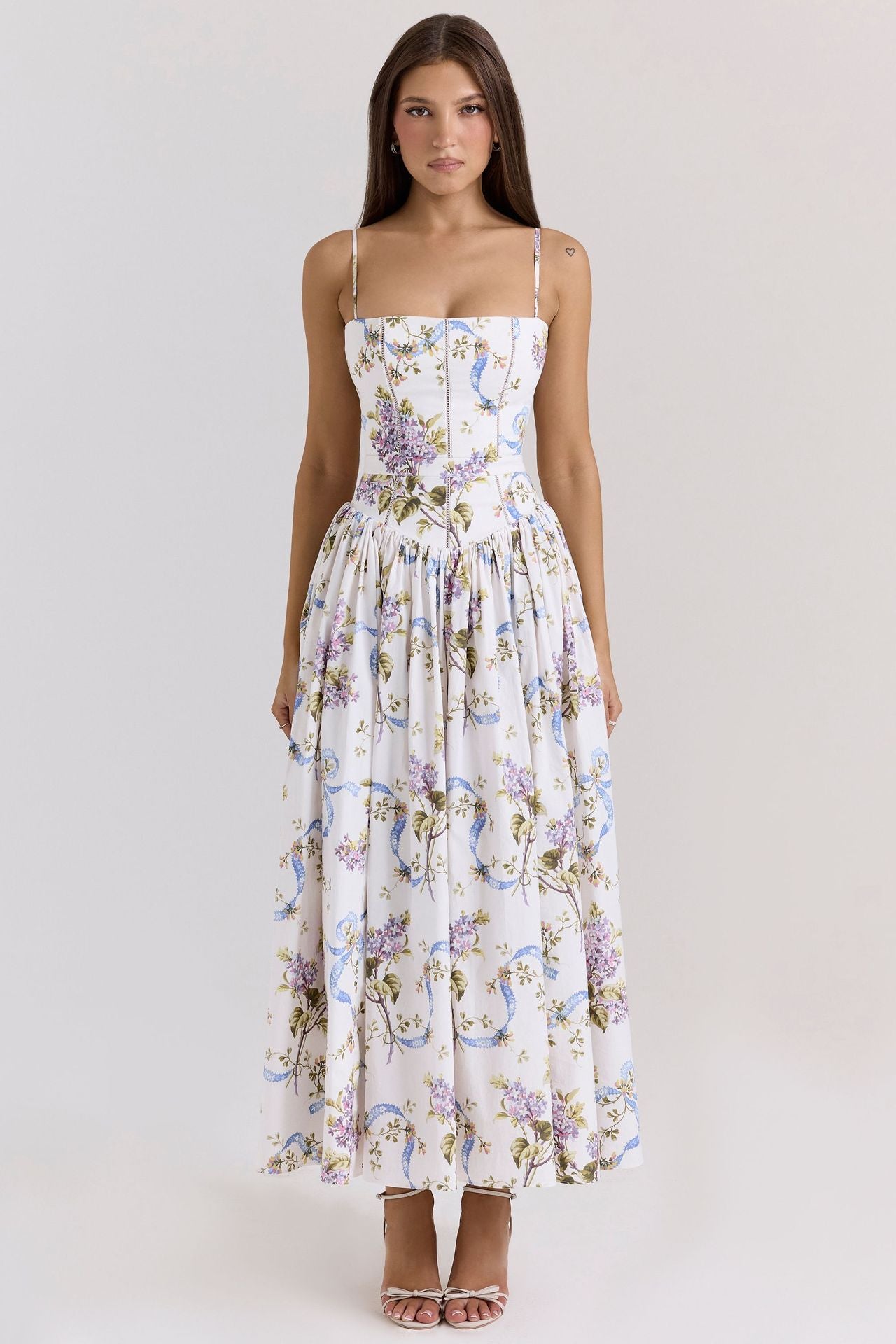 Woman wearing a floral dress on a white background
