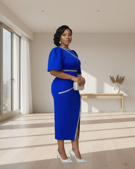 Woman in a blue dress standing in front of a card-themed backdrop