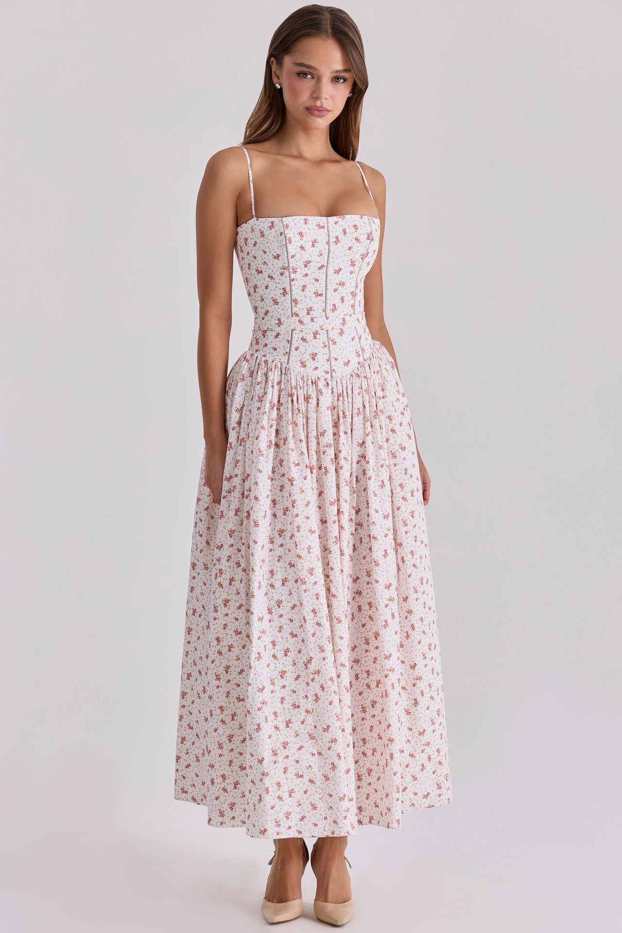 Woman wearing a floral dress on a white background