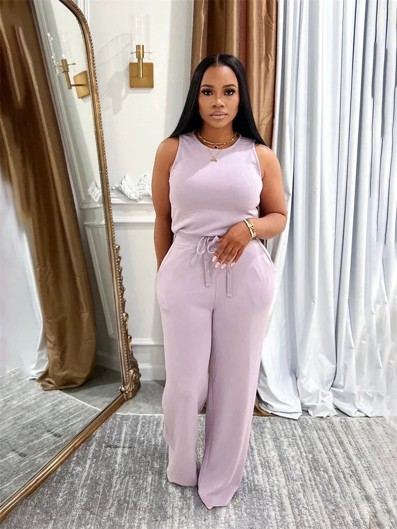 Woman in a lavender outfit standing in front of a mirror.