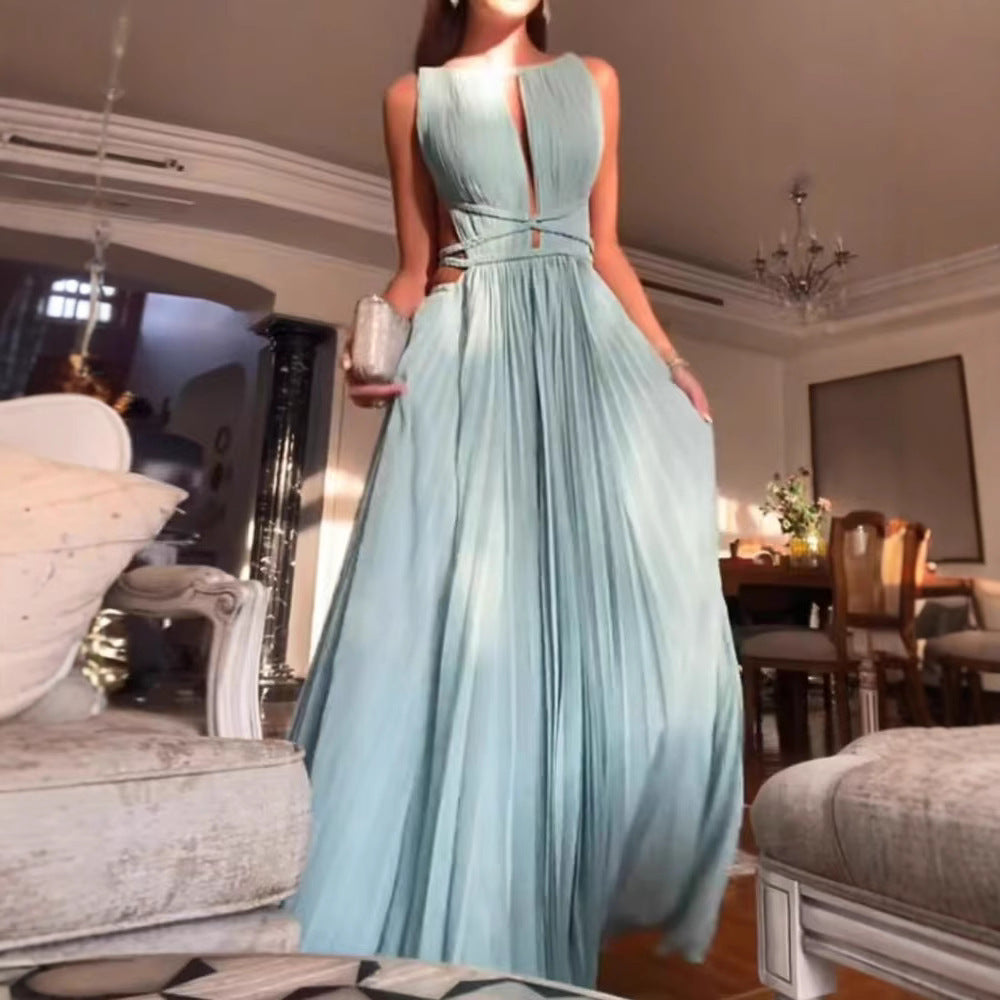 A woman in a light blue evening gown standing in a decorated room.
