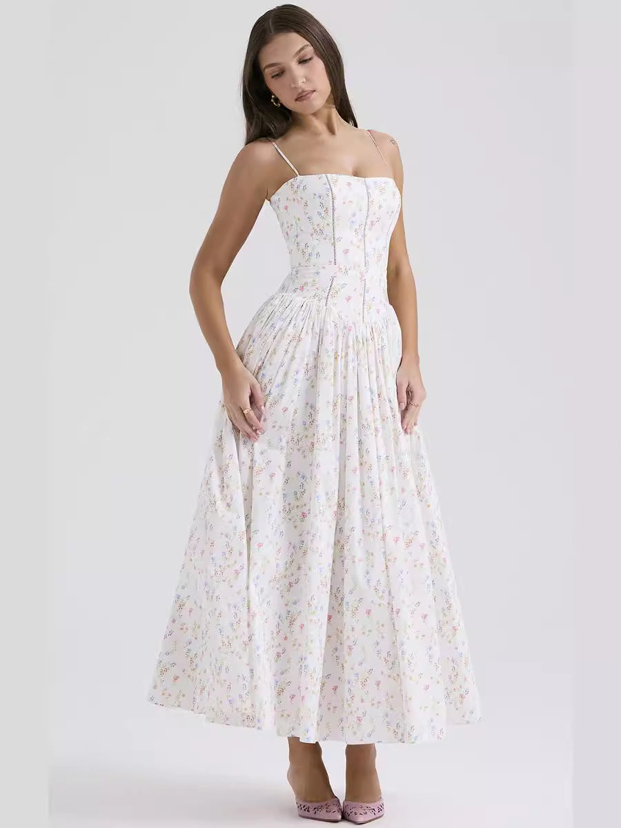 Woman wearing a white floral dress on a plain background