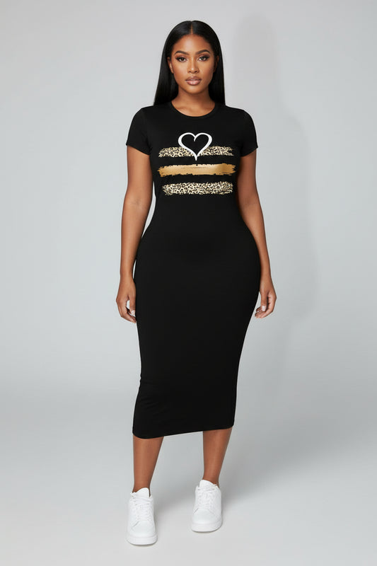 Woman wearing a black dress with a heart design on a city street.