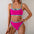 Woman wearing a pink bikini with blue straps against a white background