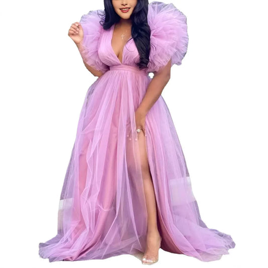 Woman wearing a pink evening gown with puffed sleeves on a white background