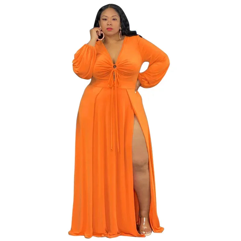 Woman wearing an orange evening gown with a slit on a white background