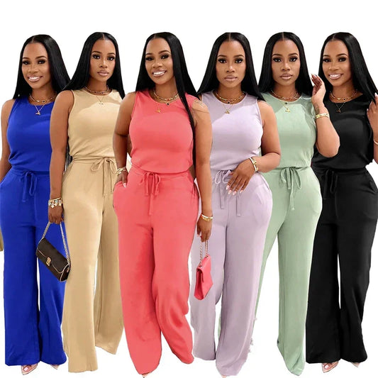 Seven women wearing colorful jumpsuits on a white background